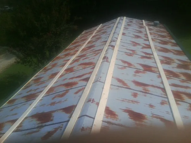 Rusted metal roof panels with new wood purlins before replacement — Storm Damage Roof Repair in Radnor by Roofing Brothers